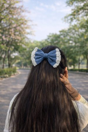 Blue denim bow hair clip with pearl work styled on hair