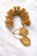Golden flower gajra hair accessory with pearl detailing for bridal and festive wear